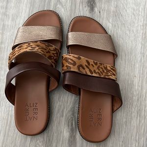 Ladies, summer sandals, with gold band, tiger, print, and brown band.